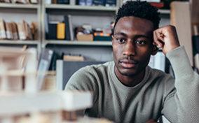 Man-touching-his-temple-while-thinking