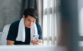 A-man-sits-on-the-toilet-looking-at-his-phone