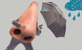 A nose with arms and legs hold an umbrella against a rain cloud.