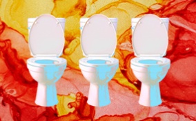 Three toilets sit in front of a yellow and red marbled background.