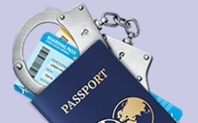 A-passport-lies-on-top-of-a-boarding-pass-and-handcuffs