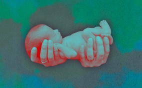 Two-hands-holding-a-premature-baby