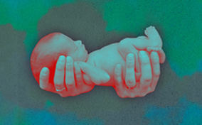Two-hands-holding-a-premature-baby