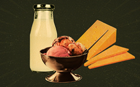 A bottle of milk, ice cream, and cheese sit against a brown background.