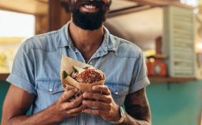 A-bearded-man-holds-a-burger