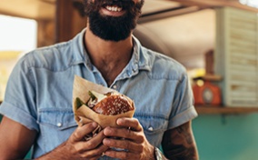 A-bearded-man-holds-a-burger