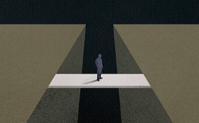 A man is crossing over a bridge to the other side.