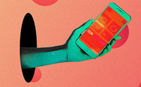 A hand reaches through a hole, holding a phone.