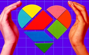 Two hands surround geometric pieces that form a heart.