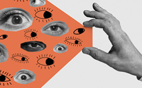 A hand holds between its thumb and pointer fingers an orange beam with eyes inside.