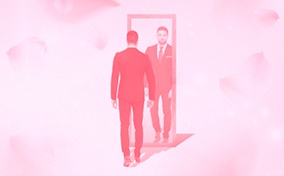 A man stands in front of a mirror with a pink cloudy background.