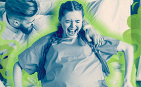 A man stands next to a woman in labor with a green odor cloud around her.