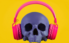 A purple skull wearing pink headphones sits on a bright yellow background.