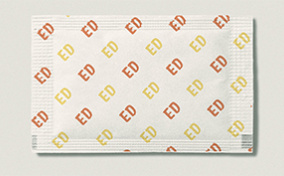 A sugar packet has ED written in yellow and orange repeatedly in a pattern.