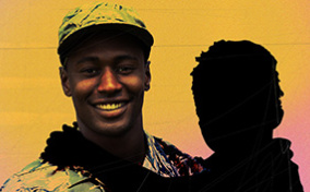 A male US Army soldier is holding a child removed from the image to signify pregnancy loss.