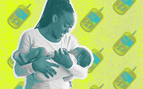 A mom smiles down at the baby in her arms over a background of blood sugar monitors.