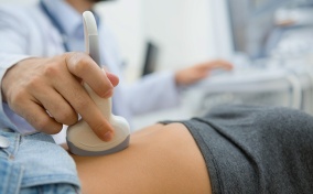 A woman is getting an ultrasound done on her pelvic region.