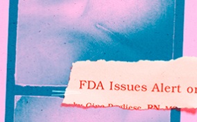 A torn piece of paper with an FDA safety announcement is stuck on a pink and teal image of a breast surgery scar.