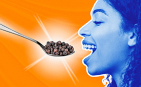 A blue woman opens her mouth for a spoon full of pepper corns.
