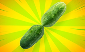A zucchini with a pinched center has bright green and yellow beams shining from the hourglass shape.