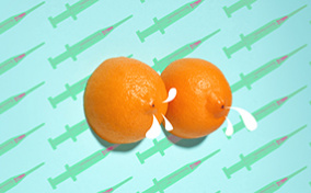 Two halfs of an orange sit side-by-side with milk coming from the ends against a background of botox needles.