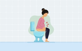 A pregnant woman sits on a toilet, holding her belly, with red lightning surrounding the baby bump.