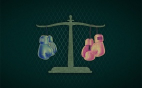 A double pan scale has blue boxing gloves hanging on the left and pink on the right.