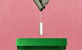 A grey hand drops a tampon into a green trash can against a pink background.