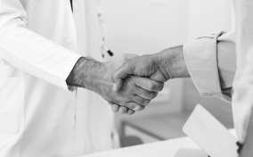 A man shakes hands with a doctor.