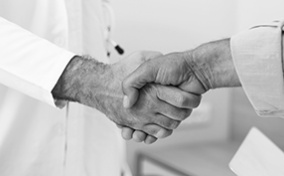 A man shakes hands with a doctor.