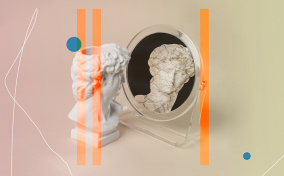 A marble bust of a head looks into a mirror and sees a cracked reflection of itself.