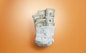 A diaper is wrapped around seven bundles of hundred-dollar bills.
