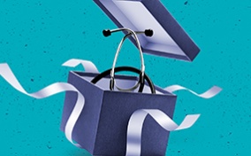 A stethoscope is coming out of a blue gift box as the white ribbon around it falls away.