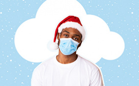 A white cloud is behind a man with a santa hat and a mask as his head tilts to the left.