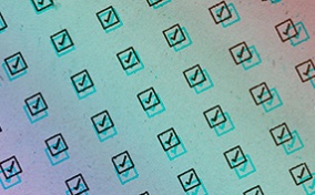 A pattern of checked boxes repeat on a rainbow-colored background.