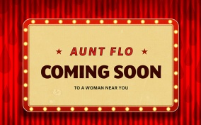 A retro coming soon sign for Aunt Flo is lit and hanging onto a red curtain with dark red droplets.