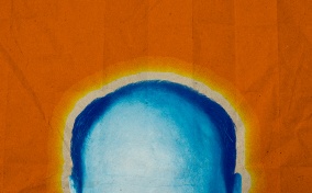 The top of a balding, blue head is in front of an orange background.