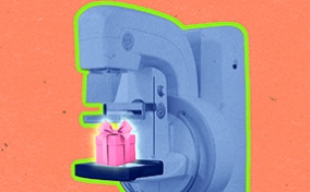 A pink gift sits on a blue mammogram unit against a coral background.