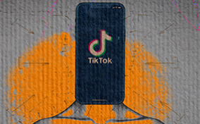 A cellphone shows the TikTok app as it sits on a body in place of a head.