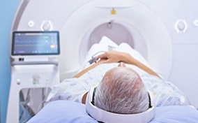A man lays on an MRI machine for his prostate biopsy.