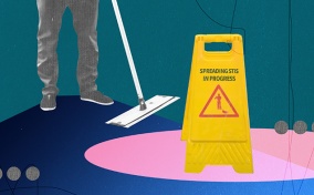 A janitor stands behind a wet floor sign that says Spreading STIs in Progress.