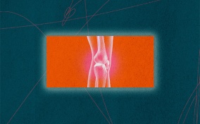 An x-ray of a leg is against an orange background with the knee joints glowing.