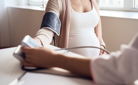 A pregnant woman has her blood pressure taken.
