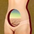 A female body has a hole in the center of its abdomen with the landscape of a dried-up lake bed in it.