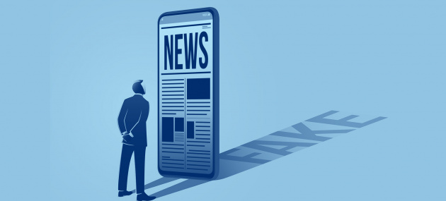 A man stares at cellphone larger than him with the news on it.