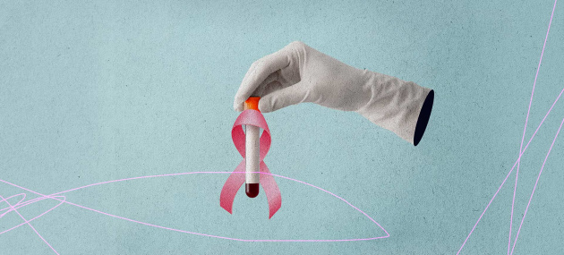 A white-gloved hand holds a vial of blood with a pink breast cancer awareness ribbon around it.