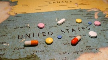 Pills are scattered over a map of the US.