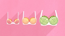 A row of three different sizes of fruit are held in bras against a pink background.