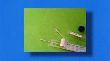 green square with test tube, cotton swab and other hormone test kit materials on blue background